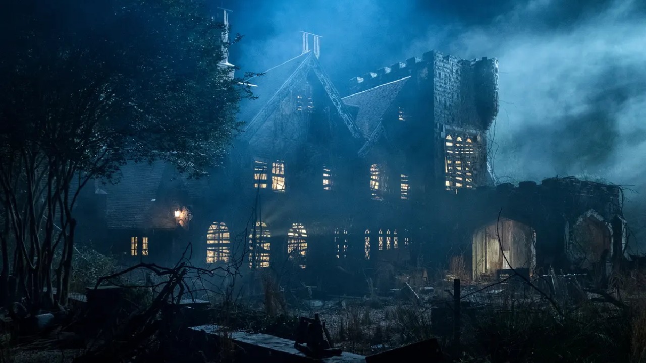 A large decrept mansion looms amid a dark misty night