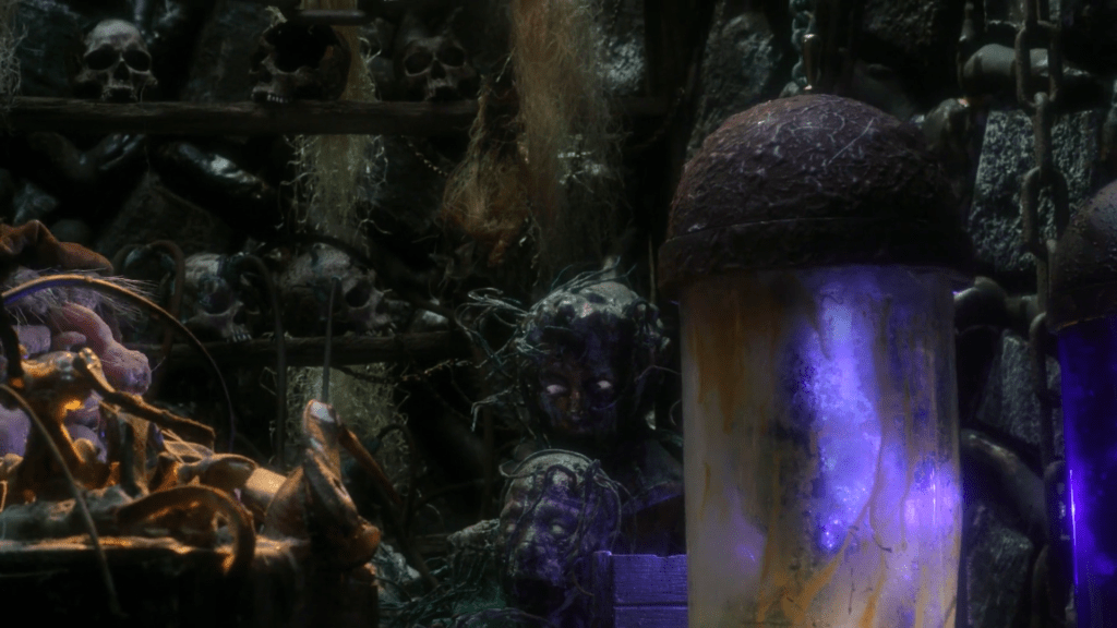 A laboratory with human heads attached to strange machines. On the side a purple glow.