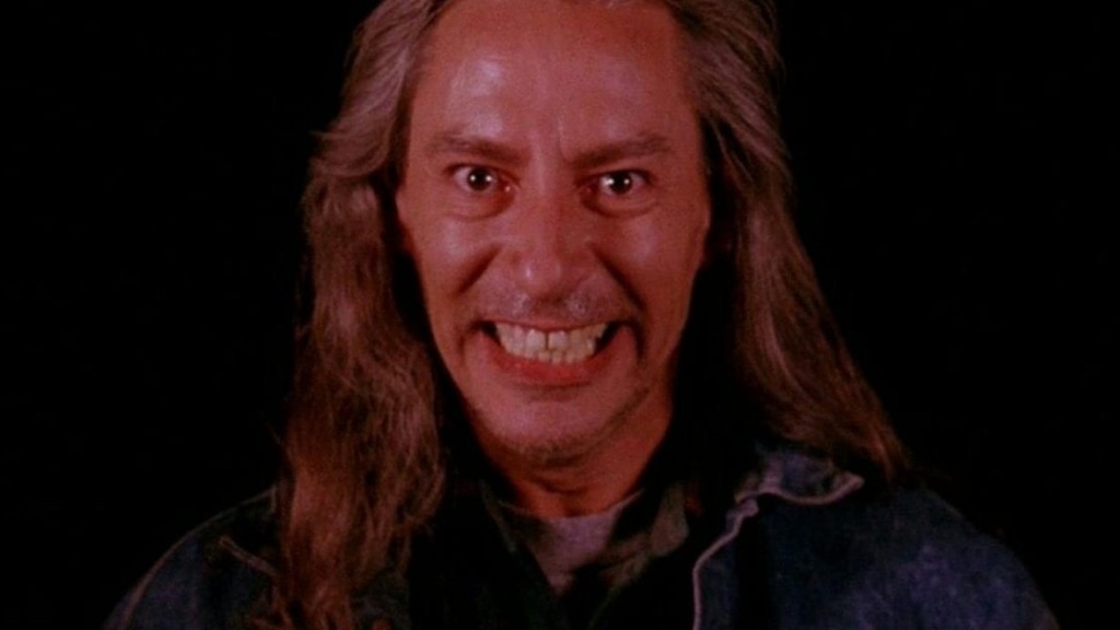 A  long-haired man with a maniacal grin.