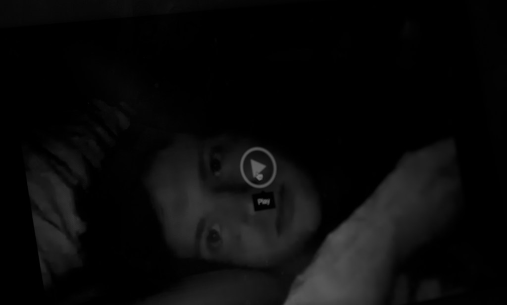 A video of someone up close, the play button ready to press.